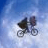 A pixelated animated contact sheet showing two frames of a blue sky background with a dark object and white text "E.T." on the right side.