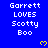 Blue background with white pixelated text reading 'Garrett LOVES Scotty Boo' and yellow pixelated hearts scattered across the image.