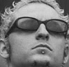 A person with curly hair and sunglasses appears in three grayscale variations, each showing different contrast levels.