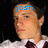 A pixelated image of a person in a white shirt and dark tie with blue text above the head, set against a black background.