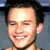 Static 50x50 pixel icon showing a close-up of a person's face with dark hair, visible teeth in a smile, and light skin tone against a gray background.