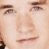 Two side-by-side pixelated close-up views of a person's face showing different facial expressions and hair color.