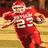 Pixelated image of a football player in red uniform with number 23 running, next to Rutgers logo on gray background.