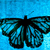 Pixelated butterfly with black body and translucent blue-green wings against a gradient blue background.