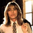 A pixelated image of a person with long hair wearing a white shirt and striped tie against a bright pink background with green text reading "Surrender to Robin".