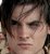 Pixelated close-up of a person's face with dark hair, visible eyes, nose, and mouth against a blurred background.