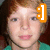 Pixelated close-up of a person with light skin and brown hair wearing a green top, with an orange and white icon overlay on the right side.