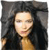 A pixelated portrait of a person with long dark hair, light skin, and a neutral expression against a dark background.