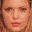 A pixelated image of a person with light skin tone, brown eyes, and reddish-brown hair in three distinct facial expressions across separate