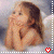 A pixelated image of a child with brown hair and angel wings, hands clasped near the face, with a red heart symbol at the bottom center.