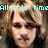 A four- pixelated image of a person with light brown hair, displaying text fragments in cyan pixelated font