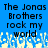 Blue background with black pixelated text reading 'The Jonas Brothers rock my world' and a white pixelated wave pattern at the bottom.