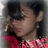 Pixelated static image of a person with dark hair wearing a red patterned top, viewed from the side with a blurred background.