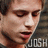 Pixelated close-up of a person's face with closed eyes, wearing dark clothing and displaying partial text 'JOSH' in white block letters.