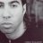 Static grayscale buddy icon showing a close-up of a person's face with visible facial features and partial hair, rendered in low-resolution pixelation.