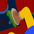 Pixelated static image shows a character's face with green hair, brown skin, and yellow clothing against red and blue background elements.
