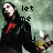 Pixelated image of a character in dark clothing with red accents, holding an object, against a muted green background with text reading 'let me' above.