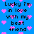 Blue background with repeated black text 'Lucky i'm in love with my best friend' and scattered pink pixelated hearts.