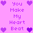 Pixelated text and heart icons on a pink background, with purple hearts surrounding the phrase "You Make My Heart Beat" in multiple arrangements.