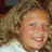A static image with a red background divided into four sections containing pixelated text and a small photo of a smiling person with curly hair.