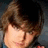 Pixelated image split into two sections: left shows a person with brown hair, right displays blue background with white text reading "I Heart Zac Effron!!".
