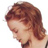 Pixelated close-up of a person's head and shoulder with brown hair, visible on a white background.