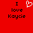 Red background with black text reading "I love Kaycie" and a white pixelated heart symbol above the word "love."