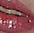 A static image of a close-up mouth with lips parted, showing teeth and tongue in a pinkish-red color palette.