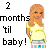 Pixelated static image of a pregnant woman with long blonde hair wearing a yellow top and colorful striped pants, next to black text reading '2 months til baby!' on white background.