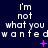 Dark blue background with repeated white pixelated text 'i'm not what you wanted' and scattered pink star-like symbols.