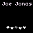 Pixelated text "Joe Jonas" repeated four times above two of white and gray plus signs on a black background
