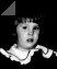 Black-and-white animated sequence showing a child's face with changing expressions and a shifting triangular overlay on a dark background.