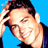Pixelated static image of a smiling man with dark hair wearing a blue shirt against a solid bright blue background, captured as a 48x48 buddy icon frame from a larger source.