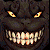 A static pixelated image of a dark, shadowy face with glowing yellow-orange eyes and a wide, toothy grin showing multiple sharp teeth.