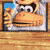 Pixelated character with brown fur, black eyes, and a blue background in a of