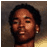 Pixelated static image of a person's face with dark hair and light skin tone against a gradient background.
