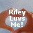 Pixelated image with white text 'Riley Luvs Me!' over a brown heart shape on light blue background.