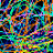 A static pixelated image composed of multicolored squares in shades of blue, green, orange, purple, and black arranged in a chaotic pattern with no discernible subjects or text.