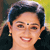 Static 50x50 pixel icon showing a close-up of a person with dark hair styled in an updo, wearing earrings and a bindi on the forehead, against a blurred background with yellow and green tones.