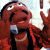 A split-frame animated contact sheet showing a cartoon character on the left and green text logo on the right against dark background.