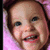 A pixelated image of a smiling child with brown hair and blue eyes, next to red text reading "McGin Eato Babio!" on black blocks against gray background.