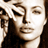 Pixelated static image of a person's face with closed eyes and hand near cheek, rendered in sepia tones on transparent background.