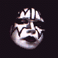 Four stylized faces with black-and-white makeup on a dark background, each in distinct poses and expressions.