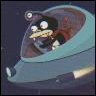 A teal and brown spaceship with a transparent cockpit containing a small character with white eyes and a yellow mouth, set against a dark background.