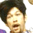 Pixelated static image of a person's face with dark hair and light skin, cropped to show upper head and shoulders against white background.