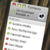 Static image of a contact list interface with green and red square icons, gray text fields, and a black-and-white heart icon in the top-right corner.