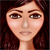 Pixelated close-up of a person's face with brown hair, light skin tone, and neutral expression against dark background.