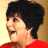 A 48x48 pixel animated contact sheet showing two frames: a person with short dark hair in profile wearing red, and a red house icon with "ARRESTED DEVELOPMENT" text above it.
