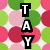 A vertical stack of three black rectangular blocks with white letters T, A, Y on a background of green and pink circles.
