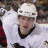 Pixelated hockey player in white jersey with black collar and helmet, holding stick, next to text "Tomas Surovy #43" and Pittsburgh Penguins logo on gray background.